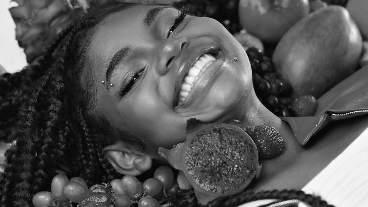 A cheerful woman surrounded by diverse Brazilian fruits, captured in a lively and colorful portrait.